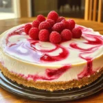 - 1 ½ cups graham cracker crumbs - ½ cup unsalted butter, melted - 1 tablespoon granulated sugar - 16 oz cream cheese, softened - 1 cup granulated sugar - 1 teaspoon pure vanilla extract - 3 large eggs, at room temperature - 1 cup sour cream, at room temperature - 1 cup fresh raspberries - 3 tablespoons raspberry jam The ingredients for this cheesecake are simple yet essential for great flavor. The graham cracker crumbs form a crunchy base. I love using unsalted butter for a richer taste. It helps bind the crust well. The granulated sugar in the crust adds a hint of sweetness. Cream cheese is the star of this dessert. It gives that creamy texture we all crave. Room temperature cream cheese mixes in easily, so always plan ahead. Adding sour cream makes it even creamier and adds tang. Fresh raspberries bring a burst of fruity flavor. You can also use raspberry jam to enhance the taste. It creates a beautiful swirl in the cheesecake. Each bite will be a mix of sweet and tart. - Alternative crust options: Oreo crumbs, almond flour - Dairy-free cream cheese alternatives If you want to switch up the crust, try Oreo crumbs for a chocolatey twist. Almond flour is another good choice for a gluten-free option. For a dairy-free cheesecake, look for cream cheese made from nuts or soy. - Choosing the best raspberries - Importance of room temperature ingredients When picking raspberries, look for bright color and firmness. Avoid berries that are mushy or dull. Freshness matters for the best flavor. Using room temperature ingredients is key. Cold eggs or cream cheese can lead to lumps. Let them sit out for about an hour before you start. This small step will make your cheesecake smooth and creamy. For the full recipe, check out the instructions to create this delightful dessert! To make the graham cracker crust, start with 1 ½ cups of graham cracker crumbs. Add ½ cup of melted unsalted butter and 1 tablespoon of granulated sugar. Mix well until it looks like wet sand. Press this mixture into the bottom of a 9-inch springform pan. This gives you a sturdy base. Bake it at 325°F for 10 minutes. This step makes the crust firm and tasty. For a smooth cheesecake filling, use room temperature ingredients. Start with 16 oz of softened cream cheese in a large bowl. Beat it with an electric mixer on medium speed until creamy. Gradually add in 1 cup of granulated sugar and mix until smooth. Next, add 1 teaspoon of pure vanilla extract. Then, add 3 large eggs, one at a time. Mix on low speed after each egg to blend well. Finally, fold in 1 cup of room temperature sour cream until combined. This will give your cheesecake a rich and creamy texture. To make the raspberry swirl, mash 1 cup of fresh raspberries with 3 tablespoons of raspberry jam in a small bowl. Use a fork to create a chunky sauce. Once your cheesecake batter is in the pan, dollop the raspberry mixture on top. Then, take a knife or toothpick and gently swirl the raspberry sauce through the cheesecake. This creates a beautiful marbled effect. Be careful not to over-swish; you want to see the red and white. Bake the cheesecake for 50-60 minutes at 325°F. Look for a slight jiggle in the center. This means it is done. After baking, turn off the oven. Crack the oven door open and let the cheesecake cool for about 1 hour. This slow cooling helps prevent cracks. Afterward, refrigerate the cheesecake for at least 4 hours, or overnight. This ensures it sets perfectly. When ready to serve, run a knife around the edge before taking off the springform pan. Enjoy your perfectly creamy Raspberry Swirl Cheesecake! To get a creamy cheesecake, mix the cream cheese on medium speed. This helps avoid lumps. Take your time when adding eggs. Add them one at a time. Each egg should mix in well before adding the next. After mixing, fold in sour cream gently. This keeps the batter smooth. Cooling your cheesecake is key. Once baked, turn off the oven. Crack the oven door and let it cool slowly. This helps prevent cracks on the surface. If your cheesecake cracks, don't worry! You can fix it. Cover the crack with fresh raspberry sauce. It adds flavor and looks nice. If the cheesecake is too sweet, add a pinch of salt. This can balance the sweetness. You can also mix in a bit of lemon juice for a fresh taste. Raspberry swirl cheesecake shines when served cold. Top slices with fresh raspberries for color and taste. You can also drizzle extra raspberry sauce on top. Pair this dessert with coffee or dessert wines. These drinks enhance the cheesecake's rich flavors. For a fun twist, serve it with whipped cream or ice cream. This adds extra creaminess and joy to each bite. For the full recipe, check the details above! {{image_4}} You can use many fruits for the swirl. Try strawberries or blueberries for a new taste. Both fruits add sweet and tart notes, just like raspberries. If you love chocolate, add cocoa powder to the batter. You can also swirl in melted chocolate for a rich twist. The look of your cheesecake matters. Try garnishing with fresh fruit or mint leaves. You can also add a drizzle of raspberry sauce on top. For a fun twist, serve mini cheesecakes in jars. This way, everyone gets their own treat! Want a low-carb cheesecake? Use almond flour for the crust instead of graham crackers. You can sweeten it with a low-carb sweetener like erythritol. If you need it gluten-free, use gluten-free graham crackers or nuts for the crust. These swaps make the dessert fit various diets. To keep your Raspberry Swirl Cheesecake fresh, use an airtight container. Glass or plastic containers work well. Make sure the cheesecake is completely cooled before storing. If you don’t have a container, wrap the cheesecake tightly in plastic wrap. This helps seal in moisture and flavor. You can freeze your cheesecake for later enjoyment. First, let it cool completely. Then, wrap it in plastic wrap. Make sure it is snug. Next, place it in a freezer-safe container. This will prevent freezer burn. To thaw, move the cheesecake to the fridge for about 6 hours. This keeps the texture creamy and smooth. In the fridge, your cheesecake lasts about 5 to 7 days. Always check for signs of spoilage. Look for any changes in smell or color. If you see mold, throw it away. Keeping it covered helps maintain its freshness, so you can enjoy every slice. Making Raspberry Swirl Cheesecake takes about 20 minutes of prep time. After that, you need to bake it for 50-60 minutes. Once it bakes, let it cool in the oven for 1 hour. Finally, refrigerate it for at least 4 hours, but overnight is best. Altogether, it takes around 6 hours to enjoy this creamy dessert. Yes, you can use frozen raspberries. However, they may change the texture a bit. Fresh raspberries give a firmer bite and vibrant flavor. If you use frozen raspberries, thaw and drain them first. This helps prevent excess water in the cheesecake. The taste will still be good, but fresh is best for that perfect swirl. Store leftovers in an airtight container in the fridge. If you want to serve it warm, gently reheat individual pieces in the microwave. Heat them for about 10-15 seconds. You can also enjoy it cold, right out of the fridge. Either way, it remains a tasty treat! To make a mini version, use a smaller springform pan, like 6 inches. Divide the ingredients by half, but keep the same steps. Bake for about 30-40 minutes instead. Check for doneness by looking for a slight jiggle in the center. This mini treat is perfect for smaller gatherings! This blog post covered how to make delicious Raspberry Swirl Cheesecake. We explored key ingredients, detailed instructions, and handy tips. You learned about crust choices, mixing techniques, and how to avoid cracks. Flavor variations and storage tips help you enjoy your cheesecake longer. In the end, with the right steps and care, you can create a cheesecake that impresses everyone. Enjoy your baking adventure!