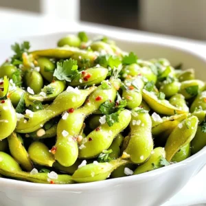 For this tasty snack, you need just a few key items: - 2 cups frozen edamame pods - 2 tablespoons extra virgin olive oil - 4 cloves garlic, finely minced - 1 teaspoon flaky sea salt - Juice of ½ fresh lime These ingredients come together to create a snack bursting with flavor. The frozen edamame offers a rich source of protein, while olive oil adds a touch of healthy fat. Minced garlic brings an aromatic punch, and flaky sea salt enhances the overall taste. The lime juice gives it a bright and zesty finish. You can add a little kick to your edamame with some optional ingredients: - 1 teaspoon crushed red pepper flakes (for heat) If you enjoy spicy food, add the red pepper flakes. They bring warmth and depth to the dish. If not, feel free to skip this step. To make your dish visually appealing, consider these garnishes: - Fresh cilantro leaves - Sliced green onions These garnishes not only add color but also fresh flavors. Sprinkle them on top before serving. For an extra touch, serve lime wedges on the side for guests to squeeze. This will allow everyone to enjoy a burst of citrus flavor according to their taste. First, set your air fryer to 390°F (200°C). Preheating helps the edamame cook evenly. This step takes just a few minutes. While you wait, gather your ingredients. In a big mixing bowl, add 2 cups of frozen edamame pods. Pour in 2 tablespoons of extra virgin olive oil. Next, add 4 cloves of finely minced garlic. Sprinkle in 1 teaspoon of flaky sea salt. If you like heat, toss in 1 teaspoon of crushed red pepper flakes. Mix everything until the edamame is well coated. Now, place the seasoned edamame into the air fryer basket. Make sure they are in a single layer. If your air fryer is small, cook in batches. Air fry the edamame for 8 to 10 minutes. Shake the basket halfway through cooking. This step helps them cook evenly. Keep an eye on the garlic to avoid burning. You want a nice golden color. Once done, take the edamame out carefully. Squeeze juice from half a fresh lime over them. This adds a fresh kick. Garnish with fresh cilantro or sliced green onions for a pop of color. Serve in a shallow bowl to show off their vibrant green. To cook edamame evenly, spread them in a single layer in the air fryer. Overcrowding can lead to uneven cooking. Shake the basket halfway through to mix them up. This step helps all pods cook well and get that nice crunch. Keep an eye on them as they cook. You want a golden color, not burnt. Garlic can burn fast in the air fryer. To avoid this, add it later in the cooking time. Try cooking the edamame for 4-5 minutes first. Then, add the minced garlic and continue cooking. This method gives you the tasty garlic flavor without the burnt bits. Air fryer garlic edamame makes a great snack or appetizer. Serve them with lime wedges on the side for a fresh squeeze. You can also pair them with beverages like beer or sake. For a fun twist, try them with a dipping sauce like soy sauce or spicy mayo. Garnish with cilantro or green onions for a pop of color. {{image_4}} If you like a kick, add crushed red pepper flakes. This spice boosts the flavor. Use one teaspoon for a mild heat. For more, try two teaspoons. You can mix the flakes in with the olive oil and garlic. This gives every pod a spicy touch. Remember, adjust the heat to your taste! You can create a fun twist by adding soy sauce or sesame oil. A splash of soy sauce makes the dish richer. You could also sprinkle some sesame seeds for a nutty crunch. Another option is to add a few drops of rice vinegar. This adds a tangy note that pairs well with garlic. Good news! This dish is already vegan and gluten-free. The ingredients are simple and clean. Use tamari instead of soy sauce for a gluten-free choice. You can also swap in coconut aminos for a sweeter flavor. These changes keep the dish healthy and fun, perfect for all diets. To store leftover edamame, let them cool completely. Place them in an airtight container. You can keep them in the fridge for up to three days. If you want them to last longer, freeze the edamame. Just make sure to use a freezer-safe bag. This way, they stay fresh for up to three months. When you’re ready to eat the leftovers, reheat them for the best taste. The microwave works well for this. Heat them in short bursts of 30 seconds. Check often to avoid overcooking. You can also reheat them in the air fryer. Set it to 350°F (175°C) and heat for about 5 minutes. Toss them halfway through to warm evenly. Frozen edamame can last a long time if stored correctly. Check the packaging for the best-by date. When stored in the freezer, they can last up to one year. Once cooked, eat them within three days for the best flavor. Always check for any signs of freezer burn or off smells before cooking. Yes, you can use fresh edamame. Fresh edamame cooks faster than frozen. You should steam fresh edamame pods for about 3-5 minutes before air frying. This helps to soften them, so they cook evenly. You can follow the same steps as the frozen version, but adjust the time in the air fryer. Keep an eye on them as they may need less time. To adjust the spice level, you have options. If you want more heat, add extra crushed red pepper flakes. If you like it milder, reduce or skip the flakes. You can also add a dash of hot sauce after cooking. Taste as you go to find your perfect balance. You can get creative with seasonings. Some tasty options include soy sauce, sesame oil, or a sprinkle of smoked paprika. You could also try adding ginger for a bit of zing. Experiment until you find a mix that you love! This guide covered how to make air fryer garlic edamame from start to finish. We discussed key ingredients, cooking steps, and smart tips to enhance your dish. Explore variations like spicy options or Asian flavors to keep things exciting. Store leftovers properly to enjoy them later. This simple recipe brings a tasty, healthy snack to your table. Enjoy air frying and impress your friends with your skills. Your new favorite snack is just a click away!
