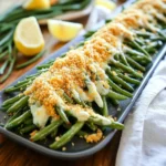 - 1 pound fresh green beans, trimmed and washed Fresh green beans are the star of this dish. Look for bright green beans that snap when you bend them. They should not be limp. Wash them well, and trim the ends. This step makes them ready for the air fryer. - 1 tablespoon extra virgin olive oil - 1/2 cup freshly grated Parmesan cheese - 1 teaspoon garlic powder - 1/2 teaspoon onion powder - 1/4 teaspoon red pepper flakes (adjust according to spice preference) - Salt and freshly cracked black pepper to taste The magic lies in the seasonings. Olive oil helps the cheese stick. Parmesan cheese adds a rich flavor. Garlic powder and onion powder give depth. Red pepper flakes add a bit of heat. Salt and pepper enhance all the flavors. You can adjust the spice level to fit your taste. - 1/4 cup panko breadcrumbs (optional, for added crunch) If you want extra crunch, add panko breadcrumbs. These breadcrumbs make the beans even crispier. Toss them in with the other ingredients. This step is not required, but it can make a big difference. First, set your air fryer to 400°F (200°C). Preheating takes about 5 minutes. This step is key for even cooking. You want those green beans to get crispy, not soggy. Next, take 1 pound of fresh green beans. Trim the ends and wash them well. In a large bowl, add the green beans. Pour in 1 tablespoon of extra virgin olive oil. Toss the beans gently until they are coated with oil. This helps the seasoning stick. Now, it’s time to season. Add 1/2 cup of freshly grated Parmesan cheese. Then, mix in 1 teaspoon of garlic powder, 1/2 teaspoon of onion powder, and 1/4 teaspoon of red pepper flakes if you like some heat. Finally, sprinkle in salt and black pepper to taste. Mix well until every bean is covered in the tasty blend. If you want extra crunch, add 1/4 cup of panko breadcrumbs. Gently toss the mixture again. Be careful not to break the beans. Now, it’s time to arrange the beans. Place them in the air fryer basket in a single layer. Don’t overcrowd; if needed, cook in batches. This ensures they cook evenly. Cook the green beans for 8 to 10 minutes. Shake the basket halfway through to help them crisp up. They should come out looking golden and delicious. Once done, let them sit for about a minute before serving. Enjoy your crispy green beans! To get that crispy texture, use fresh green beans. Trim them well and wash them thoroughly. Olive oil is your friend here; it helps the cheese stick and crisp up. Preheat your air fryer to 400°F (200°C) for even cooking. Arrange the beans in a single layer. If they are too crowded, they won't crisp up right. Shake the basket halfway through cooking. This step helps all the beans cook evenly. You can customize the seasoning to your taste. If you love garlic, add more garlic powder. For some heat, increase the red pepper flakes. You can also try different spices, like smoked paprika or Italian herbs. Don’t forget the salt and pepper; they make a big difference. Taste the bean mixture before cooking to ensure the flavors are just right. Serve these green beans on a pretty platter. A sprinkle of fresh Parmesan on top makes them look fancy. Add lemon wedges for a zesty touch. You can pair these green beans with grilled chicken or fish for a complete meal. They also make a great snack on their own. Enjoy them hot for the best flavor and crunch! {{image_4}} You can switch up the cheese in this recipe. Try using sharp cheddar or crumbled feta. Both add unique flavors. Grate or crumble the cheese before mixing it with the green beans. This change can give a new twist to your dish. Cheese adds richness and depth. Just remember to adjust the amount to your taste. Want to add more flavor? You can mix in a variety of spices. Try smoked paprika for a smoky kick. Or add lemon zest for a bright taste. You can even toss in some chopped fresh herbs like thyme or basil. Garlic powder is a great start, but fresh minced garlic can add more punch. The options are endless, so feel free to get creative. If you need a vegan option, skip the cheese. Use nutritional yeast instead. It gives a cheesy flavor without dairy. For a gluten-free version, simply leave out the panko breadcrumbs. You can also use gluten-free breadcrumbs if you want that extra crunch. These swaps keep your dish tasty while fitting your diet needs. After enjoying your Air Fryer Crispy Parmesan Green Beans, you may have some leftovers. To store them, let the beans cool completely. Place them in an airtight container. They will stay fresh in the fridge for up to three days. Make sure to label your container with the date. This helps you track freshness. Reheating these green beans can be tricky. You want to keep them crispy. To do this, use your air fryer again. Preheat it to 350°F (175°C). Place the green beans in the basket in a single layer. Heat them for about 3 to 5 minutes. Check them often to avoid overcooking. This method keeps the beans crunchy and tasty. Freezing crispy green beans is possible, but they lose some texture. If you want to freeze them, first cool them completely. Spread them out on a baking tray in a single layer. Freeze for about an hour until they are firm. After that, transfer them to a freezer bag. Remove as much air as possible before sealing. They can last up to three months in the freezer. When you’re ready to eat them, reheat in the air fryer as mentioned above. To keep your green beans crispy, ensure you coat them lightly with olive oil. If you add too much oil, they may become soggy. It's also key to preheat your air fryer. This helps cook the beans quickly, giving them a nice crunch. Arrange the beans in a single layer in the basket. Do not overcrowd them. This allows hot air to circulate freely for even cooking. Finally, shake the basket halfway through cooking to help them crisp up. Yes, you can make this recipe without Parmesan cheese. The green beans will still taste great. Try using nutritional yeast for a cheesy flavor without dairy. You could also use a different cheese, like cheddar or feta. Just remember, the taste will change based on your choice. If you skip the cheese, be sure to add extra seasonings to keep the flavor strong. The best dipping sauces for crispy green beans include ranch dressing and garlic aioli. Both add creamy flavor that pairs well with the crunch of the beans. You can also try a spicy sriracha sauce for a kick. Soy sauce or a sweet chili dip can add an Asian twist. Feel free to get creative! Mixing different sauces can also lead to fun new flavors. We covered how to make crispy green beans in the air fryer. Fresh green beans, spices, and add-ins can boost flavor. I shared tips for crispness and adjusting taste. You can try different cheeses or make it vegan. Storing leftovers and reheating keeps them tasty. With these steps, you can enjoy this dish anytime. Try it and make your green beans shine!