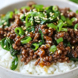 - 1 lb ground beef or lean ground sirloin - 3 tablespoons soy sauce - 1 tablespoon sesame oil - 2 tablespoons brown sugar - 1 tablespoon gochujang - 2 cloves garlic, minced - 1-inch piece of fresh ginger, grated - 2 green onions, finely chopped (reserve some for garnish) - 1 cup jasmine rice or cauliflower rice - 1 cup fresh spinach or bok choy - 2 teaspoons sesame seeds - Salt and pepper When I create Korean beef bowls, I focus on fresh ingredients. They make a big difference in flavor. The base starts with ground beef, or you can use lean ground sirloin for a healthier choice. Each bite needs the right balance of savory and sweet. The soy sauce, sesame oil, and brown sugar combine to make a delicious sauce. Gochujang adds a spicy kick that really brings the dish to life. Minced garlic and grated ginger round out the taste. I love using fresh green onions to add a nice crunch. For the rice, I often pick jasmine rice, but cauliflower rice works well for a low-carb option. Spinach or bok choy adds a great color and nutrients. Don't forget the sesame seeds! They add a lovely crunch and look great on top. Finally, season with salt and pepper to your taste. These ingredients come together to make a tasty and satisfying meal. {{ingredient_image_2}} - Heat a large skillet on medium heat. - Add 1 pound of ground beef to the skillet. Cook for 5-7 minutes. - Stir frequently, breaking apart clumps with a spatula. Brown the beef well. - If there is excess fat, carefully drain it out. - In a small bowl, mix 3 tablespoons soy sauce, 1 tablespoon sesame oil, 2 tablespoons brown sugar, and 1 tablespoon gochujang. - Add 2 cloves minced garlic and 1 inch grated ginger to the bowl. - Whisk all the ingredients until they blend well. - Pour this tasty sauce over the browned beef in the skillet. Stir to coat the beef evenly. - Add 2 finely chopped green onions to the skillet. - Season with salt and pepper to taste. Mix well. - To prepare the greens, steam 1 cup of spinach for 2 minutes until just wilted. - Choose a bowl and scoop in 1 cup of jasmine rice or cauliflower rice as the base. - Top the rice with the savory beef mixture and the spinach. - Garnish your dish with a sprinkle of sesame seeds and some extra chopped green onions. For the best taste, adjust the sauce to fit your liking. You can add more gochujang if you want extra heat. Using fresh ingredients boosts flavor. Fresh green onions and ginger make a big difference. Don’t skip on these elements. They enhance the dish. To cook spinach, steaming works well. Steam it for just 2 minutes until it's wilted. If you prefer sautéing, a quick stir in oil works too. Keep an eye on the beef. Overcooking can make it tough. Cook until it's browned, about 5-7 minutes. Garnishing adds fun to your meal. Sprinkle sesame seeds and extra green onions on top. Use a deep bowl to hold all the layers. A wide bowl lets you see the colorful layers. This makes your Korean beef bowl inviting and tasty. Pro Tips Choose the Right Beef: For a leaner option, opt for ground sirloin instead of regular ground beef. It will reduce the fat content while still delivering great flavor. Balance the Heat: Adjust the amount of gochujang based on your spice preference. Start with less and add more if you prefer a spicier dish. Quick Cooking Greens: For the freshest taste, steam the spinach just until wilted. Overcooking can lead to a loss of nutrients and flavor. Perfect Rice Texture: Rinse jasmine rice before cooking to remove excess starch. This will help achieve a fluffier and less sticky texture. {{image_4}} You can easily make Korean beef bowls vegetarian or vegan. Try substituting ground beef with plant-based alternatives like lentils or veggie crumbles. These options keep the flavor but add more nutrients. Tofu is another great choice. You can cube firm tofu and sauté it until golden. Mushrooms work well too. They add a nice umami taste and texture. For a low-carb meal, swap out rice for cauliflower rice. You can pulse cauliflower florets in a food processor until they resemble rice. Sauté it with a bit of oil for flavor. Another option is to use greens instead of rice. Spinach or bok choy adds freshness without the carbs. Feel free to add other vegetables to your beef bowls. Bell peppers, carrots, or snap peas add color and crunch. Adjust the spice levels to your liking. If you want more heat, add extra gochujang or sliced chilies. You can also add a splash of lime juice for brightness. To keep your Korean beef bowls fresh, store leftovers in the fridge. Place them in an airtight container. Make sure to let the dish cool down before sealing it. This helps prevent moisture buildup. You can store the bowls for up to three days. When you want to enjoy your leftovers, the best way is to use the microwave. Place the food in a microwave-safe dish and cover it loosely. Heat it for one to two minutes, stirring halfway. This helps heat evenly. If you want to keep the beef juicy, try reheating on the stove. Heat it gently over low heat, stirring often. This keeps the texture nice. If you want to save Korean beef bowls for later, freezing is a good option. Pack the beef and rice in separate freezer-safe containers. This helps keep the rice from getting mushy. Make sure to label the containers with the date. You can freeze them for up to three months. When you're ready to eat, take the bowl out of the freezer. Place it in the fridge overnight to thaw. For a quicker method, use the microwave on the defrost setting. Once thawed, reheat as mentioned earlier. Enjoy your meal anytime! If you can't find gochujang, don't worry! You can use sriracha or red chili paste. Mix these with a bit of sugar to get a similar taste. Another option is to blend miso paste with chili powder. This can give you that nice umami flavor. Each substitute will change the taste a bit, but they can still make your dish tasty. Yes, you can prep these bowls ahead of time! Cook the beef and sauce, then store them in a sealed container. Keep the rice and greens separate to avoid sogginess. When ready to eat, just heat everything up and assemble. This way, you save time and enjoy a warm meal fast. To add heat, use more gochujang in your sauce. You can also add sliced fresh chili peppers or red pepper flakes. If you want a smoky flavor, try adding chipotle powder. Adjust this to your taste, and remember to start small. You can always add more spice later. This blog post covered the key ingredients and steps to make delicious Korean beef bowls. You learned how to cook the beef, prepare the sauce, and combine all the flavors. I shared tips for the best taste and fun variations to suit your diet. Remember, fresh ingredients make a big difference. Whether you want a quick meal or a tasty change, this dish fits the bill. Try it out and enjoy your delicious creation!