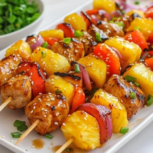 - 1 lb boneless, skinless chicken thighs, cut into 1-inch pieces - 1 cup fresh pineapple, diced into 1-inch chunks - 1 bell pepper (red or yellow), diced into 1-inch pieces - 1 small red onion, cut into wedges - 1/2 cup teriyaki sauce - 2 tablespoons soy sauce - 1 tablespoon honey - 1 tablespoon sesame oil - 2 cloves garlic, minced - 1 teaspoon ginger, grated - Salt and pepper to taste - Skewers (soaked in water for 30 minutes if wooden) - Grill or grilling pan These ingredients come together to create a delightful dish. The chicken thighs provide a juicy base, while the fresh pineapple adds a sweet punch. The bell pepper and red onion bring color and crunch. Teriyaki sauce gives everything a savory glaze that ties it all together. For the marinade, soy sauce, honey, sesame oil, garlic, and ginger blend perfectly. These flavors penetrate the chicken, making it tender and tasty. Salt and pepper add a simple touch to enhance the taste. Gathering the right equipment is key. Soak wooden skewers to prevent burning. A grill or grilling pan helps achieve those perfect grill marks. With these ingredients and tools, you are ready to make Pineapple Teriyaki Chicken Skewers that everyone will love. {{ingredient_image_2}} - To start, mix the marinade. In a large bowl, whisk together: - 1/2 cup teriyaki sauce - 2 tablespoons soy sauce - 1 tablespoon honey - 1 tablespoon sesame oil - 2 cloves garlic (minced) - 1 teaspoon ginger (grated) - Add salt and pepper to taste. This mix creates a tasty base for your chicken. - Next, add 1 pound of boneless, skinless chicken thighs cut into 1-inch pieces. Make sure each piece is coated well. Cover the bowl with plastic wrap. Let it sit in the fridge for at least 30 minutes. For a stronger flavor, marinate for up to 2 hours. - If you use wooden skewers, soak them in water for 30 minutes. This keeps them from burning on the grill. - Now, it's time to assemble. Take the marinated chicken and thread it onto the skewers. Alternate with 1-inch chunks of fresh pineapple, bell pepper, and red onion. This adds color and taste. Leave small gaps between the pieces for even cooking. - Preheat your grill to medium-high heat. Clean the grill surface and lightly grease it. This helps prevent sticking. - Place the skewers on the hot grill. Cook them for about 12 to 15 minutes. Turn the skewers every few minutes. This ensures they cook evenly. The chicken should reach an internal temperature of 165&deg;F (75&deg;C). Look for nice grill marks as a sign of doneness. - In the last few minutes, brush the skewers with any leftover teriyaki sauce. This gives them a delicious glaze. - Once cooked, take the skewers off the grill and let them rest for a few minutes. This step keeps them juicy and tender. To ensure your chicken is fully cooked, check its internal temperature. Use a meat thermometer to confirm it reaches 165&deg;F (75&deg;C). This will keep the chicken safe to eat and juicy. For perfect grill marks, avoid moving the skewers too much. Let them sit for a couple of minutes on each side before flipping. Brushing the skewers with teriyaki sauce while grilling adds a rich flavor. Do this in the last few minutes of cooking for a nice glaze. For a colorful and tasty finish, consider garnishing with sesame seeds and chopped green onions. These add a fresh touch and make your dish look appealing. Cut your chicken and vegetables into 1-inch pieces for even cooking. This size helps everything cook at the same rate. When assembling the skewers, alternate chicken with pineapple, bell pepper, and onion. This not only looks good but also ensures that all ingredients get the heat they need for a perfect bite. Pro Tips Marinate for Maximum Flavor: The longer you marinate the chicken, the more flavorful it becomes. For best results, aim for at least 2 hours of marination, or overnight if you have the time. Choose the Right Skewers: If you prefer wooden skewers, remember to soak them in water for at least 30 minutes. This prevents burning and ensures they hold up on the grill. Check for Doneness: To ensure the chicken is fully cooked, use a meat thermometer. The internal temperature should reach 165&deg;F (75&deg;C) for safe consumption. Garnish for Presentation: A sprinkle of sesame seeds and chopped green onions not only enhances the dish's visual appeal but also adds a burst of flavor that complements the skewers. {{image_4}} You can switch the chicken for shrimp or tofu. Shrimp cooks fast and offers a sweet taste. Tofu absorbs flavors well and is great for vegans. If you want beef or pork, they work well too. Just remember to adjust cooking times for these proteins. Adding zucchini or mushrooms can change the dish. Zucchini gives a nice crunch, while mushrooms add a rich flavor. You can also use cherry tomatoes. They burst with juice when cooked, adding freshness to your skewers. For a spicy kick, try a hot teriyaki sauce. It adds heat and depth. You can also make a citrus-infused marinade. Just mix in orange or lime juice for a bright twist. This enhances the sweetness of the pineapple and chicken. After grilling, let your skewers cool down. Place them in an airtight container. This helps keep moisture in. Store the container in the fridge. Leftover skewers last up to three days in the fridge. To reheat, use a microwave or an oven. For the microwave, place skewers on a plate. Heat for about 1-2 minutes. If using an oven, preheat to 350&deg;F (175&deg;C). Heat for about 10 minutes. Serve with a drizzle of teriyaki sauce for extra flavor. To freeze, wrap each skewer in plastic wrap. Place them in a freezer-safe bag. Remove as much air as possible. They&rsquo;ll stay fresh for up to three months. Thaw in the fridge overnight before grilling. This keeps the chicken tender and tasty. You should marinate the chicken for at least 30 minutes. This will infuse some flavor into the meat. For a deeper taste, I suggest marinating for 2 hours. Longer marination helps the chicken soak up the marinade&rsquo;s goodness. Just make sure not to exceed 4 hours, as it can become too salty. Yes, you can use store-bought teriyaki sauce. This option saves time and works well. However, homemade sauce lets you control the taste. Store-bought sauces may have added sugar or preservatives, while homemade can be fresh and clean. If you want a richer flavor, I recommend making your own. These skewers pair great with rice or noodles. Steamed jasmine rice or fried rice complements their flavors well. You can also serve a fresh salad on the side. Try a simple cucumber salad or a green salad for added crunch. The sweetness of the pineapple brings a nice contrast to savory sides. This blog post outlined how to make tasty pineapple teriyaki chicken skewers. We discussed the main ingredients, like chicken thighs and fresh pineapple, along with key marinade components. I detailed the necessary equipment and provided clear step-by-step grill instructions. We also explored tips for perfect chicken, different protein variations, and storage information. Enjoy experimenting with flavors and ingredients. Your skewers will impress friends and family! Get grilling, and savor each bite.