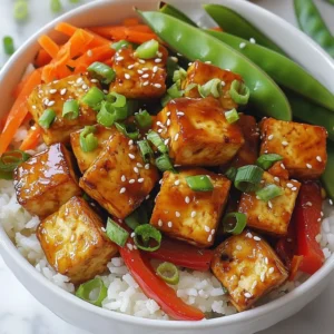 - Firm tofu and its preparation: For this dish, use 400g of firm tofu. Press it to remove excess moisture. This step helps the tofu get crispy. Cut the pressed tofu into 1-inch cubes. - Vegetables for stir-fry: I love adding fresh colors and textures. Use 1 red bell pepper, thinly sliced. Add 1 cup of snap peas, trimmed, and 1 medium carrot, julienned. These veggies give a nice crunch. - Flavoring agents: Garlic and ginger are key. Use 3 cloves of minced garlic and 2 tablespoons of minced ginger. Add 2 tablespoons of soy sauce for saltiness. One tablespoon of chili paste adds heat. Finally, mix in 1 tablespoon of maple syrup for sweetness. - Sesame seeds: These add a nutty crunch. Sprinkle them on top before serving. - Chopped green onions: Use 3 finely chopped green onions. They add freshness and color. - Recommended grains: Serve your chili garlic tofu over cooked jasmine rice or quinoa. Both options soak up the sauce nicely. - Additional toppings: Consider adding lime wedges. A squeeze of lime brings brightness to each bite. {{ingredient_image_2}} How to press and cut tofu Start by pressing the firm tofu. This step removes extra moisture, which improves texture. Wrap the tofu in a clean kitchen towel and place a heavy object on top for about 15 minutes. After pressing, cut the tofu into 1-inch cubes. Coating with cornstarch for crispiness Next, take a medium bowl and add the cubed tofu. Sprinkle 2 tablespoons of cornstarch over the tofu. Toss gently until every piece is coated. This coating gives the tofu a crispy crust when fried. Frying the tofu Heat 2 tablespoons of vegetable oil in a large skillet over medium-high heat. When the oil is hot, add the cornstarch-coated tofu cubes. Fry for 6 to 8 minutes, turning occasionally. Look for a golden brown color and crisp edges. Once done, remove the tofu and set it aside on a plate. Saut&eacute;ing garlic and ginger In the same skillet, add 1 tablespoon of vegetable oil. Once hot, add 3 cloves of minced garlic and 2 tablespoons of minced ginger. Saut&eacute; for about 1 minute. Stir constantly until fragrant but be careful not to burn them. Mixing the sauce and stir-frying vegetables Now, pour in 2 tablespoons of soy sauce, 1 tablespoon of chili paste, and 1 tablespoon of maple syrup. Mix well to create your sauce. Then, add 1 sliced red bell pepper, 1 cup of snap peas, and 1 julienned carrot to the skillet. Stir-fry these vegetables for 4 to 5 minutes. They should be tender but still colorful. Combining tofu and vegetables Return the crispy tofu to the skillet. Gently toss everything together. Ensure the tofu is well-coated with sauce and heated through. Serving over rice/quinoa To serve, spoon the chili garlic tofu mixture over cooked jasmine rice or quinoa. Add some finely chopped green onions and a sprinkle of sesame seeds for extra flavor and crunch. Tofu can be tricky, but pressing it is key. When you press tofu, you remove extra water. This step helps the tofu absorb flavors and become crispy. Here are some tips to achieve that perfect crunch: - Use firm or extra-firm tofu for the best texture. - After pressing, cut the tofu into 1-inch cubes. - Coat the cubes with cornstarch. This creates a crispy layer when fried. - Ensure the oil is hot before adding the tofu. This helps seal in moisture and promotes crispiness. Do you like it hot? You can modify the chili paste in this recipe. If you want less heat, use less chili paste. Here are a few alternatives for milder flavors: - Try using sweet chili sauce instead of chili paste. - Add a touch of honey for sweetness without the heat. - Mix in some coconut milk to tone down the spice. Want to make your dish more colorful and tasty? Adding more veggies is a great idea. You can use: - Broccoli florets for a nice crunch. - Spinach for added nutrients. - Mushrooms for a meaty texture. You can also play with different sauces or seasonings. Here are some suggestions: - Use teriyaki sauce for a sweet twist. - Add a splash of rice vinegar for tanginess. - Try sesame oil for a nutty flavor. These tips will help you create a bowl that is not only delicious but also fits your taste. Enjoy experimenting! Pro Tips Press the Tofu: Ensure you press the tofu for at least 30 minutes to remove excess moisture, resulting in a firmer texture and better absorption of flavors. Adjust Spice Levels: Taste the sauce before adding the tofu and adjust the chili paste to your preferred heat level for a perfect balance. Colorful Veggies: Use a variety of colorful vegetables to enhance not only the visual appeal but also the nutritional value of the dish. Garnish for Flavor: Don&rsquo;t skip the sesame seeds and green onions; they add a delightful crunch and fresh flavor that elevate the dish. {{image_4}} If you want to keep your dish vegan, you can make easy swaps. For the soy sauce, use tamari. This gluten-free option tastes great. Instead of maple syrup, try agave nectar. Both sweeteners add a nice touch. If you want a creamy element, use coconut yogurt as a topping instead of sour cream. Change the veggies based on what&rsquo;s fresh. In spring, add asparagus or peas. In summer, use zucchini or bell peppers. Fall brings great choices like butternut squash or mushrooms. During winter, think about using kale or Brussels sprouts. These swaps keep your dish bright and tasty. Want to switch up your protein? Tempeh is a great choice. It absorbs flavors well and has a hearty texture. You can also use seitan, which is very meaty. If you want to keep it simple, chickpeas or black beans can work too. Each option brings its own flavor and nutrition to your bowl. To store leftover chili garlic tofu bowls, follow these steps: - Allow the bowl to cool completely before storing. - Use an airtight container for best results. - Keep in the fridge for up to 3 days. - If possible, store the tofu separate from the rice or quinoa. This keeps everything fresh and tasty. To reheat without losing texture, you have a few options: - Stovetop: Heat a skillet over medium heat. Add a splash of water or oil. Place the tofu and veggies in the skillet. Stir gently until warm. - Microwave: Use a microwave-safe dish. Cover loosely with a lid or paper towel. Heat in short bursts, checking often. This method may soften the tofu. - Oven: Preheat to 350&deg;F (175&deg;C). Spread the tofu and veggies on a baking sheet. Heat for about 10-15 minutes. This helps keep the crispness of the tofu. Yes, you can freeze chili garlic tofu bowls! Follow these tips: - Let the dish cool completely before freezing. - Place in a freezer-safe container, leaving space for expansion. - Freeze for up to 2 months. - When ready to eat, thaw overnight in the fridge. Reheat using your favorite method. Freezing may change the texture of the tofu slightly, but it still tastes great! You can prep the tofu and veggies one day ahead. Press and cut the tofu into cubes. Toss it with cornstarch and store it in the fridge. Chop your veggies and keep them in an airtight container. You can also mix the sauce ingredients and store them separately. On the day you want to eat, just fry the tofu and stir-fry your veggies. This keeps everything fresh and tasty. Firm tofu works best for these bowls. It holds its shape well during cooking. Silken tofu is too soft and won&rsquo;t give you a nice texture. Extra-firm tofu is even denser, which is great for frying. If you want crispy edges, choose firm or extra-firm tofu. They soak up flavors well and give the bowls a lovely crunch. If you want less heat, use a mild sauce like sweet chili sauce. You can also blend red pepper flakes with soy sauce for a quick fix. If you love spice, try sriracha or harissa. Both add a nice kick. For those who avoid spice, use a dash of soy sauce and a hint of garlic for flavor without the heat. This blog post showed you how to create tasty Chili Garlic Tofu Bowls. You learned about the key ingredients, from firm tofu to fresh veggies. I walked you through easy steps, ensuring your tofu is crispy and flavorful. Plus, you discovered tips for storage and making variations. In summary, cooking should be fun and flexible. Explore the flavors and ingredients that excite you. Enjoy making this satisfying dish again and again!