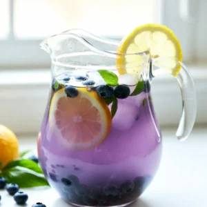 - 1 cup fresh blueberries - 1 cup fresh basil leaves - 1 cup freshly squeezed lemon juice (about 4-5 lemons) Fresh ingredients are key to great taste. Fresh blueberries give a sweet and tart flavor. They also add a pretty color. Fresh basil leaves bring an herby note that pairs well with the lemon. Use only ripe, juicy lemons for the best juice. They should feel heavy and firm. - 1 cup granulated sugar - 4 cups water, divided - Ice cubes Granulated sugar sweetens the drink. You can adjust the amount to fit your taste. Water helps mix all the flavors and makes the lemonade light and refreshing. Ice cubes are a must for that cool, crisp sip on hot days. - Lemon slices - Basil sprigs Garnishing adds a fun touch. Lemon slices give a pop of color and extra flavor. Basil sprigs look great and smell amazing. Together, they make your drink look fancy and inviting. {{ingredient_image_2}} 1. Start by taking 1 cup of fresh blueberries. Place them in a medium saucepan. 2. Add 1 cup of water and 1 cup of granulated sugar to the pan. 3. Put the saucepan over medium heat. Stir the mix gently. 4. Bring it to a gentle simmer. This should take about 5-7 minutes. 5. Keep stirring until the sugar dissolves and the blueberries burst. 6. Once done, take the pan off the heat and let it cool for a few minutes. 7. Next, strain the blueberry mix using a fine mesh sieve. 8. Press the solids with a spoon. This helps to extract more juice. 9. Discard the solid bits and keep your vibrant blueberry syrup aside. 1. Take 1 cup of fresh basil leaves. 2. Add these leaves to a blender with 1 cup of water. 3. Blend on high until the basil is finely chopped. It should look smooth. 4. Strain the basil mix through a fine mesh sieve. 5. Discard any solids left in the sieve. You want just the liquid. 1. In a large pitcher, combine the freshly squeezed juice from about 4-5 lemons. 2. Add the blueberry syrup and the basil liquid to the pitcher. 3. Pour in the remaining 3 cups of water. 4. Stir everything well to mix the flavors. 5. Taste the lemonade. If it needs more sweetness, add more sugar. 6. If it is too sweet, add more water to dilute it. 7. Cover the pitcher and place it in the fridge for at least 1 hour. This helps the flavors blend and chill. 8. To serve, fill glasses with ice cubes. 9. Pour the blueberry basil lemonade over the ice. 10. Garnish each glass with a lemon slice and a sprig of fresh basil. Enjoy your refreshing drink! To make a great blueberry basil lemonade, sweetness is key. Start with one cup of sugar, but taste it. You might want to add more or less. If it's too sweet, add more water. Cooling the drink is also important. After mixing, chill it in the fridge for at least an hour. This helps the flavors blend. Serve it cold over ice for a refreshing sip. Serving your lemonade can be fun! Use clear glasses to show off the bright color. Fill each glass with ice before pouring in the lemonade. For garnishing, add lemon slices on the rim. A sprig of fresh basil on top makes it look fancy. You can also float some blueberries in the glass for extra flair. These little touches make your drink pop! Pro Tips Choose Ripe Blueberries: For the best flavor, select ripe blueberries that are plump and juicy. They will provide a natural sweetness and vibrant color to your lemonade. Fresh Basil is Key: Use fresh basil leaves rather than dried for a more aromatic and flavorful infusion. The fresh leaves will enhance the overall taste of the lemonade. Adjust Sweetness to Taste: Depending on the tartness of your lemons and the sweetness of the blueberries, you may want to adjust the sugar. Start with less and add more as needed to achieve your desired sweetness. Chill Before Serving: Letting the lemonade chill for at least an hour allows the flavors to meld beautifully. Serve it over ice for a refreshing drink on a hot day! {{image_4}} You can make this drink even better by adding mint or other herbs. Mint brings a fresh twist. It pairs well with blueberries and basil. Simply add a handful of mint leaves when simmering the blueberries. You can also try other herbs like thyme or rosemary for unique flavors. Alternative fruits are another option. You can mix in strawberries, raspberries, or even peaches. Just blend them with the blueberries for a fruity punch. Each fruit adds its own taste and color, making your drink more exciting. If you want a healthier drink, consider using natural sweeteners. Honey or agave syrup can replace granulated sugar. They add sweetness without the refined sugar. Just remember to adjust the amount, as they might be sweeter. For sugar-free options, try using stevia or monk fruit sweetener. These alternatives work well without adding calories. Make sure to taste as you go. This way, you can find the perfect balance for your lemonade. For the best taste, chill your blueberry basil lemonade in the fridge. Use a pitcher with a lid to keep it fresh. The lemonade will stay good in the fridge for about 3 to 5 days. Always stir before serving, as some ingredients may settle. You can freeze blueberry basil lemonade for later use. Pour the lemonade into ice cube trays or freezer-safe containers. Leave some space at the top, as the liquid will expand when frozen. To serve, let it thaw in the fridge overnight or at room temperature for a few hours. If using ice cubes, blend them into a slushy drink for a fun twist. Can I use frozen blueberries? Yes, you can use frozen blueberries for this lemonade. They work well and save time. Just remember to thaw them slightly before cooking. This helps release their juices better. How do I adjust the recipe for less sugar? To reduce sugar, use less granulated sugar or try a natural sweetener. Start with half a cup and taste it. You can always add more if needed. Nutritional advantages of ingredients Blueberries are rich in vitamins and antioxidants. They help with heart health and may improve brain function. Basil adds vitamins A and K, which are great for your skin. Lemons are packed with vitamin C, boosting your immune system. Hydrating properties of lemonade Lemonade is refreshing and hydrating. The combination of water, lemon juice, and fruits helps keep you cool in summer. Staying hydrated is vital for overall health and energy. Pairing with snacks or meals Blueberry basil lemonade pairs well with light snacks. Serve it with fresh fruit, cheese, or salads. It also complements grilled chicken or fish for a summer meal. Use in cocktails or mocktails You can turn this lemonade into a fun cocktail. Add vodka or gin for a refreshing drink. For a mocktail, mix in sparkling water for bubbles without alcohol. Enjoy the flavors! This blog post shared how to make a tasty blueberry basil lemonade. We explored fresh and pantry ingredients, detailed step-by-step instructions, and offered tips for perfect results. Plus, I provided variations and storage options for your drink. In the end, this refreshing beverage boosts flavor, creativity, and health. Enjoy it on sunny days, or pair it with your favorite meals. You can impress guests and savor each sip. Try it today!