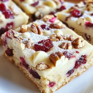 - 1 cup unsalted butter, softened - 1 cup brown sugar, packed - 1/2 cup granulated sugar - 2 large eggs - 1 teaspoon pure vanilla extract - 2 1/2 cups all-purpose flour - 1 teaspoon baking soda - 1/2 teaspoon fine salt - 1 cup dried cranberries, chopped - 1 cup white chocolate chips - 1/2 cup chopped pecans (optional) - You can swap dried cranberries with raisins or cherries. - Use dark chocolate chips instead of white chocolate for a richer taste. - Add a pinch of cinnamon for a warm spice flavor. {{ingredient_image_2}} 1. Preheat your oven to 350&deg;F (175&deg;C). This step is key for even baking. 2. Prepare your baking pan. Use a 9x13 inch pan. Grease it lightly or line it with parchment paper. This makes clean-up easier and helps the bars release. 3. Cream the butter and sugars. In a large bowl, mix 1 cup of softened unsalted butter with 1 cup of brown sugar and 1/2 cup of granulated sugar. Use an electric mixer on medium speed for 3-4 minutes. You want it light and fluffy. 4. Add the eggs and vanilla. With the mixer on low, add 2 large eggs one at a time. Make sure each egg mixes in well. Then, stir in 1 teaspoon of pure vanilla extract until just combined. 5. Mix dry ingredients. In another bowl, whisk together 2 1/2 cups of all-purpose flour, 1 teaspoon of baking soda, and 1/2 teaspoon of fine salt. This ensures even distribution. 6. Combine wet and dry ingredients. Gradually add the dry mix to the wet mix. Keep the mixer on low. Stop mixing when everything is just combined. Overmixing can make the bars tough. 7. Fold in the fun stuff. Gently mix in 1 cup of chopped dried cranberries, 1 cup of white chocolate chips, and 1/2 cup of chopped pecans if you want. Use a spatula for even distribution. 8. Transfer to the pan. Spread the dough evenly in your prepared baking pan. Smooth the top for a nice finish. 9. Bake the bars. Place the pan in the oven and bake for 25-30 minutes. Look for golden edges. A toothpick should come out clean from the center. 10. Cool the bars. Once baked, remove the pan from the oven. Let it cool in the pan for about 10 minutes. Then, move the bars to a wire rack to cool completely. 11. Cut and serve. After cooling, cut the bars into squares or rectangles. Enjoy the deliciousness! - Use room temperature ingredients. This helps with mixing and gives a better texture. - Prepare your ingredients first. Measure everything out before starting. This keeps the process smooth. - Clean as you go. It makes the kitchen less messy and more enjoyable. To ensure your cookie bars have the best texture, follow these steps: - Use softened butter: This helps the sugars blend well for a fluffy mix. - Avoid overmixing: When you add dry ingredients, mix just until combined. This keeps the bars soft. - Check your oven temperature: Ovens can vary. Use an oven thermometer for accuracy. Common mistakes can affect your cookie bars: - Not measuring ingredients properly: Use standard measuring cups for accuracy. - Skipping the cooling time: Allow the bars to cool before cutting. This helps them set. - Baking too long: Keep an eye on them. They should be golden at the edges but soft in the middle. To present your cookie bars beautifully, try these ideas: - Dust with powdered sugar: This adds a festive touch. - Drizzle melted white chocolate: This gives an elegant finish that looks great. For drinks that pair well, consider: - Coffee or tea: These warm drinks complement the sweetness. - Milk: A classic choice that balances the flavors. Feel free to explore different ways to enjoy these tasty treats! Pro Tips Use Room Temperature Ingredients: Ensuring your butter and eggs are at room temperature helps achieve a smoother batter, resulting in a better texture for your cookie bars. Don&rsquo;t Overmix: When combining the dry ingredients with the wet, mix just until you see no flour. Overmixing can lead to dense and tough cookie bars. Cool Completely Before Cutting: Allow the cookie bars to cool completely in the pan before slicing to prevent them from falling apart and to achieve clean edges. Experiment with Add-ins: Feel free to customize your cookie bars by adding different nuts, dried fruits, or even spices like cinnamon for a unique flavor twist. {{image_4}} You can easily swap ingredients for different needs. If you want a dairy-free option, use vegan butter. For a gluten-free treat, try almond flour instead of regular flour. Want to change the flavor? You can add different nuts like walnuts or almonds. You can also mix in dried fruits such as apricots or cherries for a new taste. You can adapt these cookie bars for any holiday. For Christmas, add a pinch of nutmeg or cinnamon to the batter. This gives a warm, festive flavor. For Thanksgiving, consider using pumpkin spice in the mix. It pairs well with cranberries. On Valentine&rsquo;s Day, swap in heart-shaped sprinkles for a sweet touch. These little changes can make your Cranberry Bliss Cookie Bars a hit at any gathering! To keep your Cranberry Bliss Cookie Bars fresh, store them in an airtight container. This will protect them from air and moisture. If you want to keep them longer, freezing is a great option. To freeze, wrap the bars tightly in plastic wrap or aluminum foil. Place them in a freezer-safe container. This prevents freezer burn and keeps them tasty. These cookie bars last about one week at room temperature. If you keep them in the fridge, they can last up to two weeks. When frozen, they can stay good for about three months. Just remember to thaw them in the fridge overnight before you enjoy them! To make these bars gluten-free, substitute all-purpose flour with a gluten-free flour blend. Use a blend that measures cup for cup like regular flour. This keeps the texture light and soft. Yes, you can use fresh cranberries. Chop them up and add them to the mix. Fresh cranberries are tart, so you might want to add a bit more sugar to balance the taste. If your bars turn out dry, try using less flour next time. Also, make sure to not overbake them. If they seem dry, serve them with a scoop of ice cream or a drizzle of melted chocolate for added moisture. You can make these bars more festive by adding seasonal spices like cinnamon or nutmeg. Top with a sprinkle of powdered sugar or drizzle melted white chocolate on top. You can also add festive sprinkles for color. This blog post covers how to make delicious cookie bars. You learned about required and optional ingredients, and I shared step-by-step baking instructions. I also provided tips to ensure perfect texture and ways to present your bars nicely. You can try ingredient substitutions and seasonal twists too. In closing, you now have all the tools to create tasty cookie bars. Enjoy the process and share your creations with others. Happy baking!