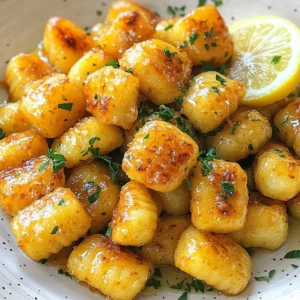 To make crispy garlic butter gnocchi, you will need: - 1 pound potato gnocchi - 3 tablespoons unsalted butter - 4 cloves garlic, finely minced - 1 tablespoon fresh parsley, finely chopped - 1 teaspoon dried oregano - Salt and freshly cracked black pepper, to taste - 1/4 cup grated Parmesan cheese (optional but highly recommended) - Lemon wedges, for serving You can add a few extras for more flavor: - Crushed red pepper flakes for some heat - Fresh basil for a sweet touch - A splash of white wine for depth If you lack some items, here are some swaps: - Use olive oil instead of butter for a lighter dish - Any fresh herb can work instead of parsley - Skip the cheese or use a dairy-free option for a vegan meal {{ingredient_image_2}} To start, bring a large pot of water to a boil. Make sure the water is bubbling hard. Add a good amount of salt, which helps flavor the gnocchi. Now, gently place the potato gnocchi into the pot. Watch them closely; they will rise to the top when they are done. This usually takes about 2-3 minutes. Once they float, carefully drain them in a colander. Let them cool for a few minutes before moving on. Next, heat a large non-stick skillet over medium heat. Add 3 tablespoons of unsalted butter to the skillet and let it melt. Once melted, it&rsquo;s time to add the finely minced garlic. Stir the garlic often for about 1-2 minutes. You want it fragrant but not brown. If garlic burns, it can taste bitter, and we don&rsquo;t want that. Now comes the fun part! Add the cooked gnocchi to the skillet. Make sure they get coated well with the garlic butter. Cook them for about 5-7 minutes. Toss them gently so they get golden brown and crispy on the outside. You want that nice crunch. Once they look perfect, add chopped parsley and dried oregano. Season with salt and freshly cracked black pepper to your taste. Toss everything again to mix well. To get that great crispy texture, use a non-stick skillet. Heat it well before adding the butter. This helps the gnocchi fry instead of steam. Cook them in a single layer for best results. Avoid crowding the pan. If needed, cook in batches. Toss the gnocchi gently to turn them without breaking. Watch them closely. You want a golden-brown color, not burnt. Start with boiling water that is well-salted. This adds flavor from the very start. Cook the gnocchi until they float, usually 2-3 minutes. Then, drain them quickly to prevent sogginess. Let them cool for a minute before adding to the skillet. This helps them crisp up better. Always use fresh gnocchi for a soft center and a nice bite. You can make this dish even better with some fun extras. Try adding cooked spinach or sun-dried tomatoes for color and taste. A sprinkle of red pepper flakes gives a nice kick. For cheese lovers, use different types like feta or goat cheese. Lemon zest also adds a bright touch. Don't be shy about playing with flavors! Pro Tips Choose Quality Gnocchi: Opt for fresh or high-quality store-bought gnocchi for the best texture and flavor. Monitor Garlic Closely: Garlic can burn quickly; keep the heat moderate and stir constantly to achieve the perfect fragrant saut&eacute;. Use a Non-Stick Skillet: A non-stick skillet prevents the gnocchi from sticking and helps achieve that crispy exterior effortlessly. Experiment with Herbs: Feel free to add different herbs like thyme or basil to customize the flavor profile of your dish. {{image_4}} You can easily make this dish vegetarian by skipping the Parmesan cheese. Just keep the garlic butter and herbs. For a vegan version, swap the butter for olive oil or vegan butter. The flavor will still shine through, and you'll keep the dish rich and tasty. Feel free to change the herbs to suit your taste. Basil, thyme, or rosemary work well in this dish. You can also add red pepper flakes for some heat. Each herb brings a new layer of flavor, making it exciting each time you cook. If you're not a fan of Parmesan, try feta or goat cheese. These cheeses add a creamy texture and nice tang. You can also mix in a bit of nutritional yeast for a cheesy flavor without dairy. Add cheese after cooking for a melty delight or use it as a garnish for extra flair. To keep your crispy garlic butter gnocchi fresh, store it in an airtight container. Let the gnocchi cool fully before packing. Place a layer of parchment paper between layers if you stack them. This helps prevent sticking. Store the container in the fridge if you plan to eat it within three days. To reheat, warm a skillet over medium heat. Add a bit of butter or oil to help crisp them up again. Toss the gnocchi in the skillet for about five minutes. Stir often to avoid burning. You can also reheat in the microwave, but they won't be as crispy. Use a microwave-safe dish and cover it loosely. Heat for 1-2 minutes. You can freeze gnocchi for later use. First, spread the cooled gnocchi in a single layer on a baking sheet. Freeze them for about an hour until they are firm. Then transfer them to a freezer bag. This way, they won&rsquo;t stick together. They can last up to three months in the freezer. When you&rsquo;re ready to cook, boil them straight from the freezer. Add a minute or two to the cooking time. Cook gnocchi for 2-3 minutes. They float to the top when ready. This means they are done. Make sure to keep an eye on them while they cook. Drain them right after cooking to avoid mushiness. Yes, you can use store-bought gnocchi. They are quick and easy to prepare. Just follow the cooking instructions on the package. This makes your meal even faster. Homemade gnocchi is great, but store-bought saves time. You can serve many tasty sides with gnocchi. A fresh salad pairs well and adds crunch. Roasted vegetables also make a great choice. If you like protein, grilled chicken or shrimp works well too. Don&rsquo;t forget the lemon wedges for a fresh kick! This article covered how to make crispy garlic butter gnocchi from scratch. We explored essential ingredients and variations to fit your taste. I shared step-by-step instructions for cooking and saut&eacute;ing, plus tips for perfect texture. You learned about storage methods and answers to common questions. Enjoying this dish can be easy and fun! Experiment with flavors and make it your own. Cooking is about creativity, so have fun and savor each bite.